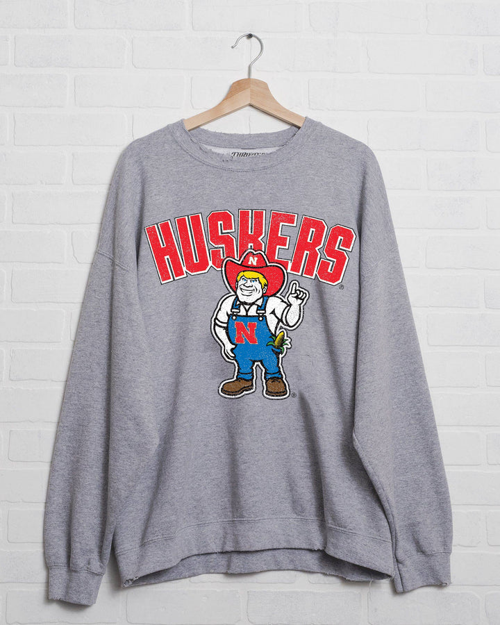 Unique Nebraska Huskers Cartoon Mascot Gray Thrifted Sweatshirt with distressed detailing, 50/50 cotton-poly blend, and unisex fit, perfect for game day, available at Onyx Native.