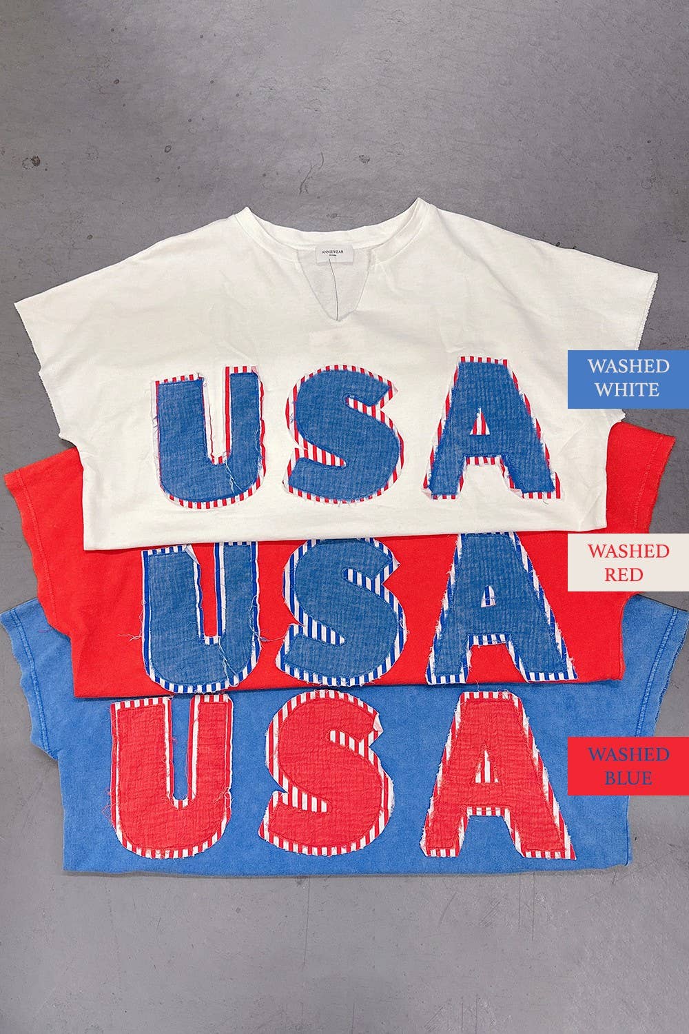 view of all colors of Mineral Washed USA Patched Knit Top with mixed fabric lettering patch, lightweight French terry, notched neckline, short dolman sleeves, raw edge details, and loose fit.