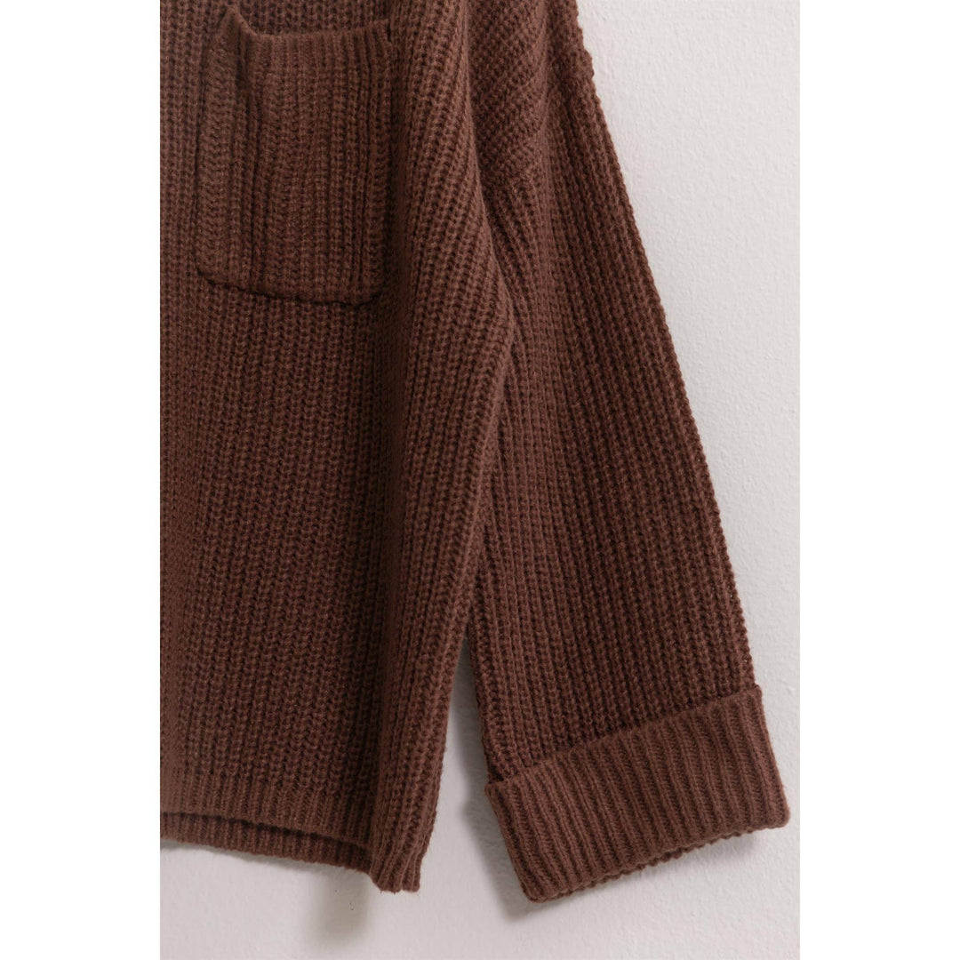 sleeve detail of Allie Oversized Pullover Sweater with all-over ribbing, round neck, and patch pocket.