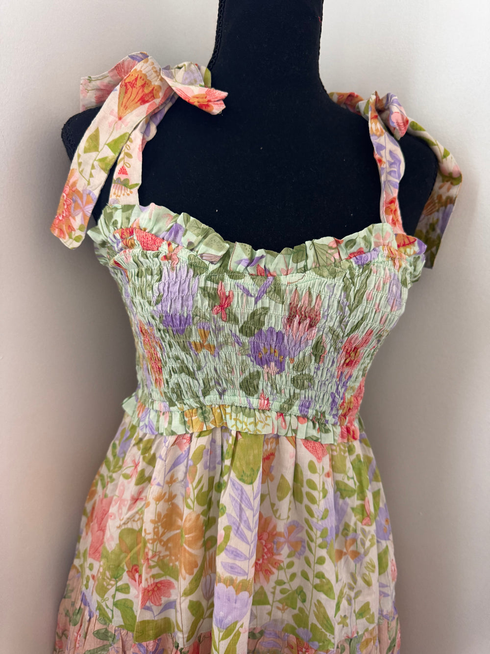 close up on neck line Garden Dream Tiered Multi Print Maxi Dress — floral print, smocked bodice, tie shoulders, true-to-size fit by Onyx Native