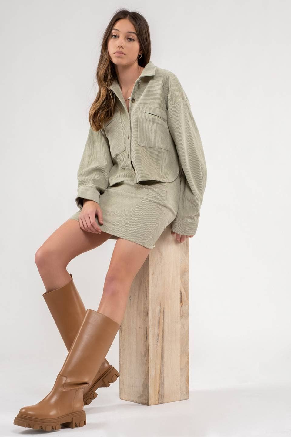 model showing full size view of Dusty Sage Button Up Rib Knit Jacket with Collar, Long Sleeves, Pockets, and Pocket Slits.