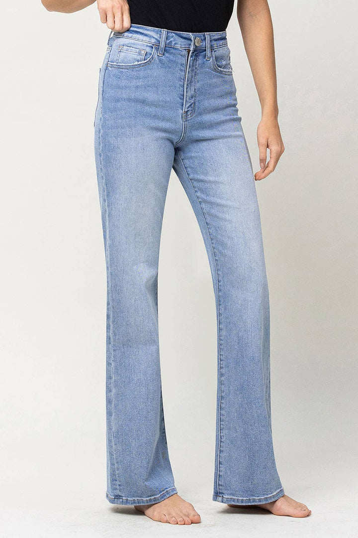 right side view of 90's vintage super high rise flare jeans with comfort stretch denim, full length, and flare legs. Front rise: 11.5 inches, inseam: 32 inches, leg opening: 20 inches. Model is 5'9'' wearing size 26.