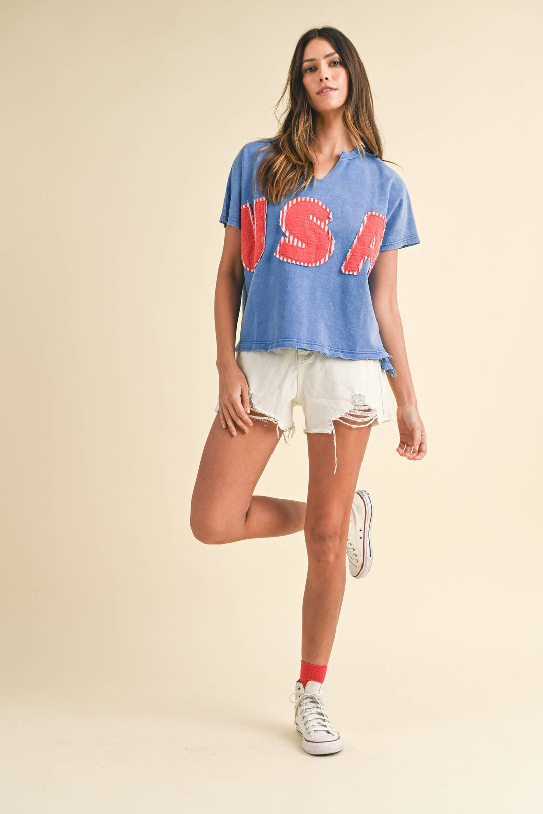 zoomed out view of Mineral Washed USA Patched Knit Top with mixed fabric lettering patch, lightweight French terry, notched neckline, short dolman sleeves, raw edge details, and loose fit.