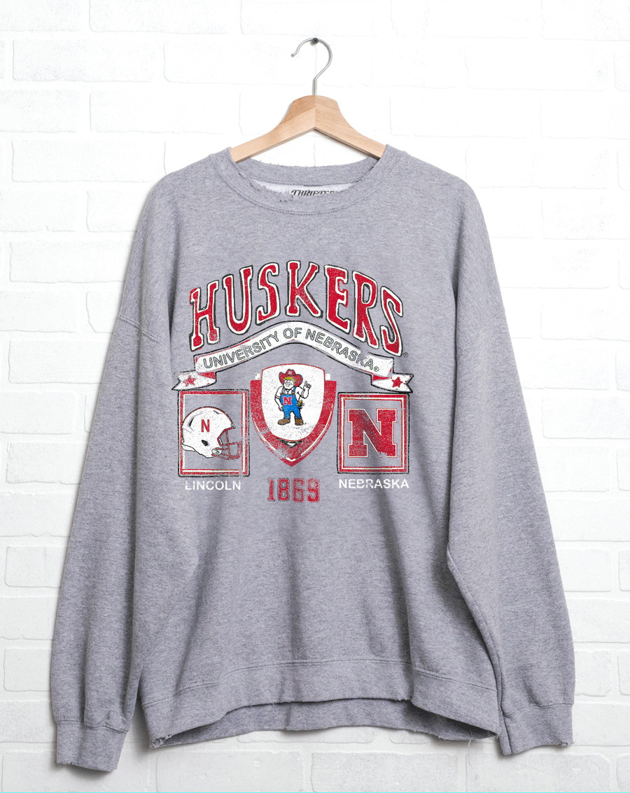 Nebraska Huskers Prep Patch Gray Thrifted Sweatshirt, 50/50 cotton/poly blend, meaningfully distressed and unique. Unisex fit, officially licensed.