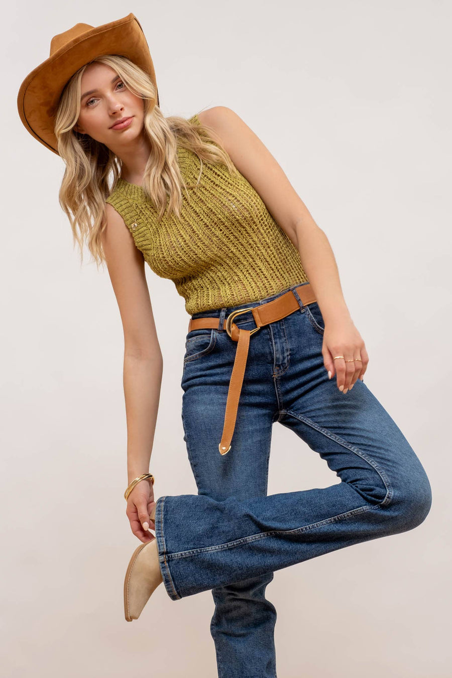 styled view of Kiwi Crochet Sweater Knit Tank Top with a round neckline and sleeveless design, made from 100% polyester.