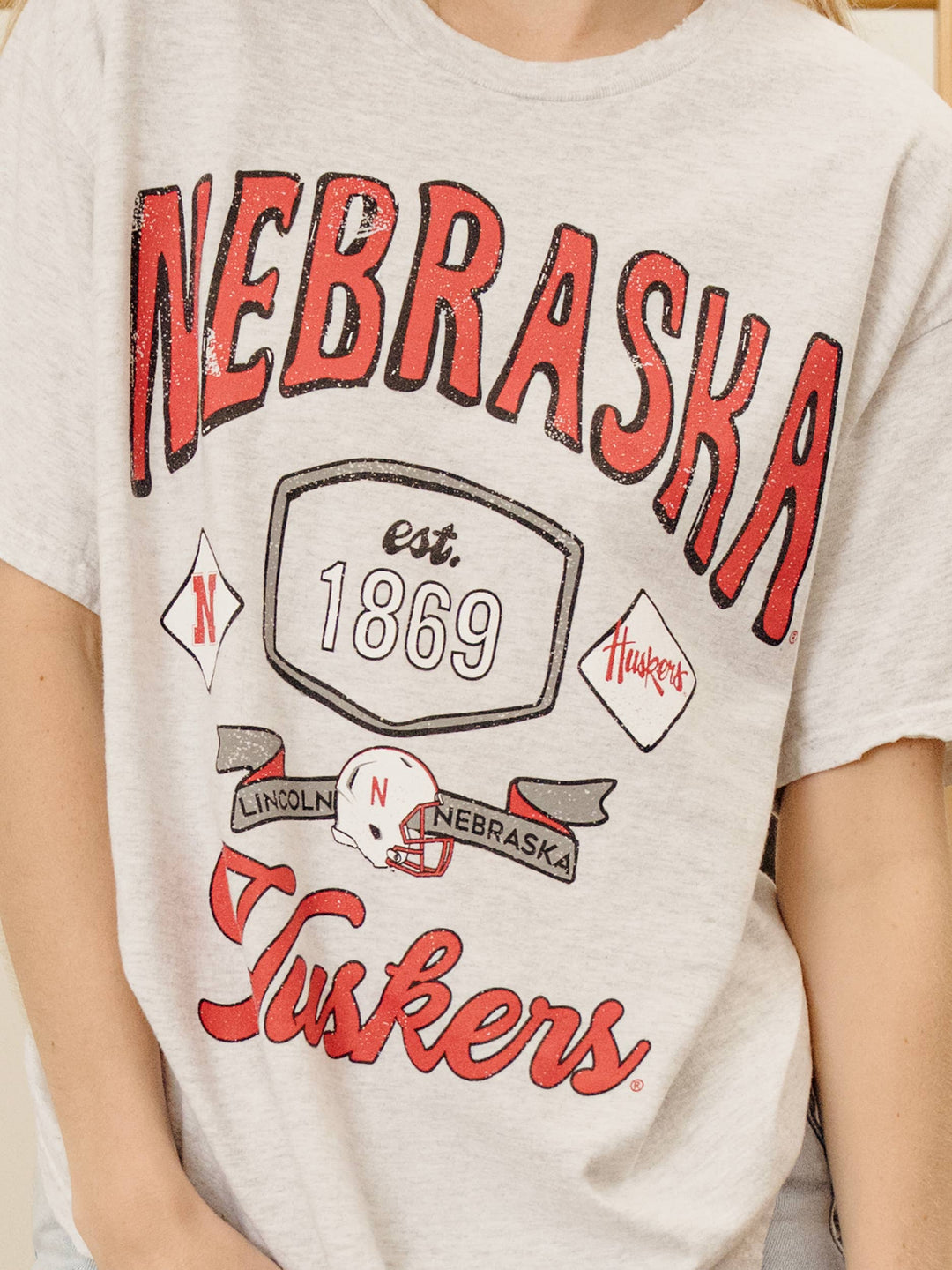 close up view Nebraska Huskers Patches Tee — distressed vintage preshrunk cotton, unisex fit, officially licensed fan gear by Onyx Native