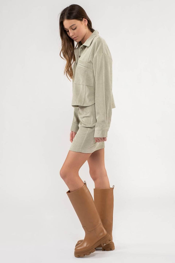 side view of Dusty Sage Button Up Rib Knit Jacket with Collar, Long Sleeves, Pockets, and Pocket Slits.