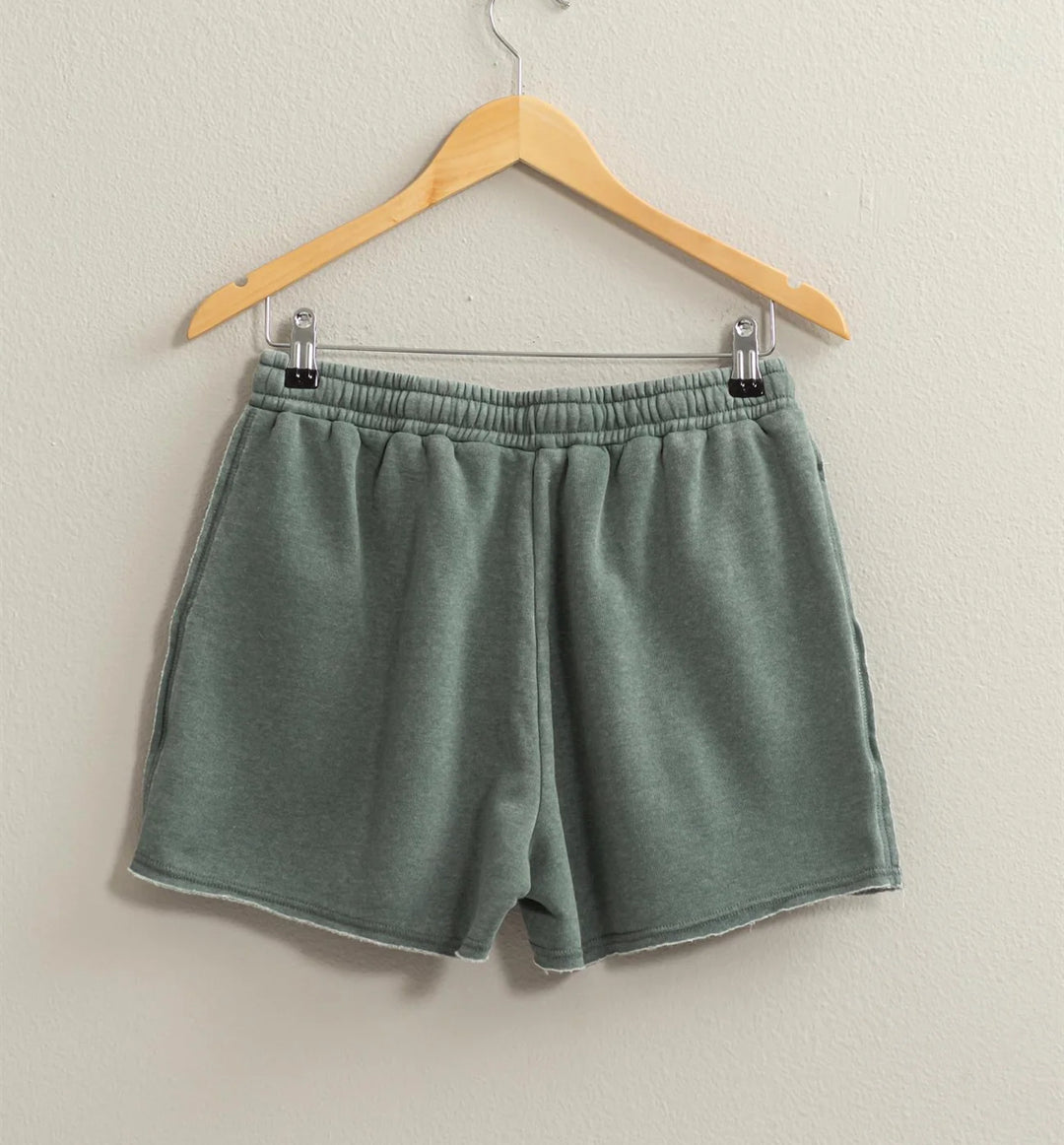back view of colored Josie Drawstring Lounge Shorts in soft stretch knit with banded waist, adjustable drawstring, and raw-cut hem. Relaxed fit for comfort. Made from 51% cotton and 49% polyester.