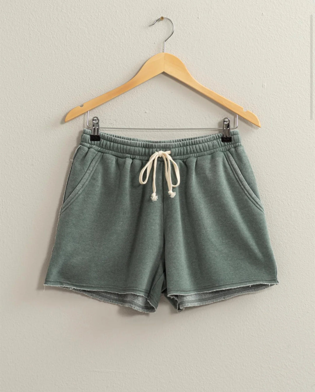 colored Josie Drawstring Lounge Shorts in soft stretch knit with banded waist, adjustable drawstring, and raw-cut hem. Relaxed fit for comfort. Made from 51% cotton and 49% polyester.