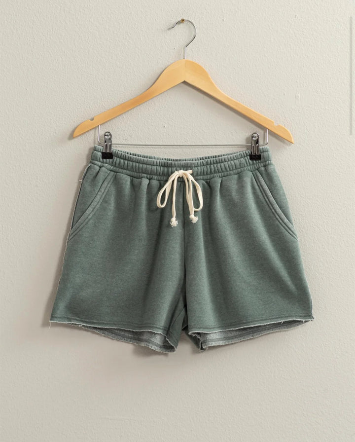 colored Josie Drawstring Lounge Shorts in soft stretch knit with banded waist, adjustable drawstring, and raw-cut hem. Relaxed fit for comfort. Made from 51% cotton and 49% polyester.