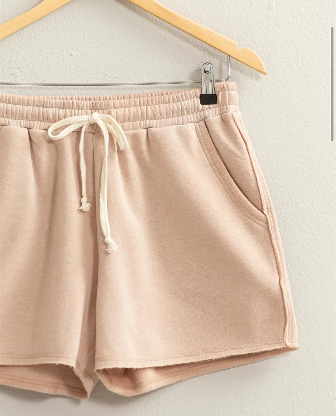 close up of Josie Drawstring Lounge Shorts in soft stretch knit with banded waist, adjustable drawstring, and raw-cut hem. Relaxed fit for comfort. Made from 51% cotton and 49% polyester.