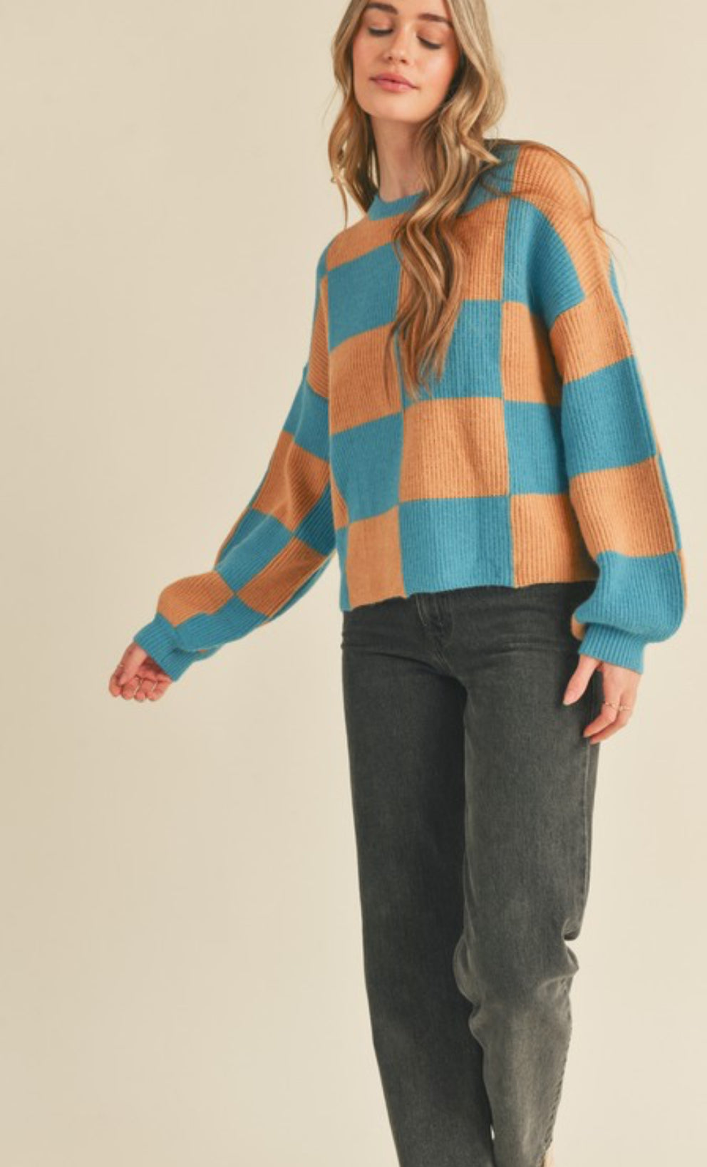 Oversized Check Mate sweater with a crewneck design and ribbed sleeve and neck details. Features a true-to-size fit.