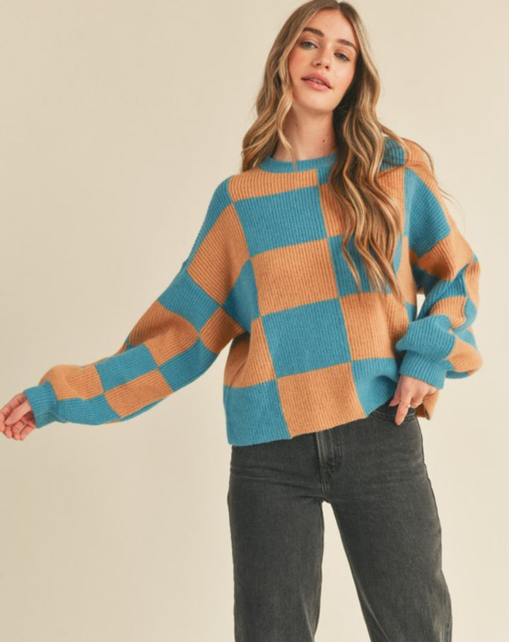 front view of Oversized Check Mate sweater with a crewneck design and ribbed sleeve and neck details. Features a true-to-size fit.