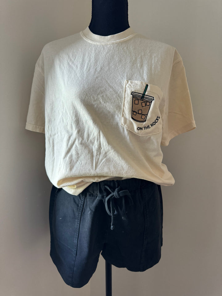 mannequin view of 'On the Rocks' Embroidered Pocket Tee in cream with custom colors. Perfect for coffee lovers.