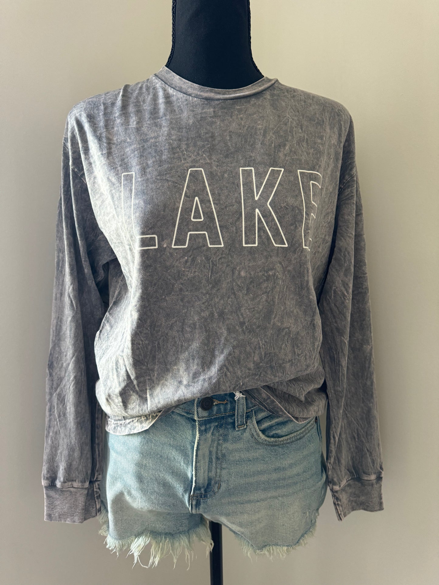 mannequin view of LAKE Mineral Washed Long Sleeve Graphic Top, 100% cotton jersey, relaxed boxy fit, cuffed sleeves, screen-printed with water-based ink, exclusive Oat Collective label.