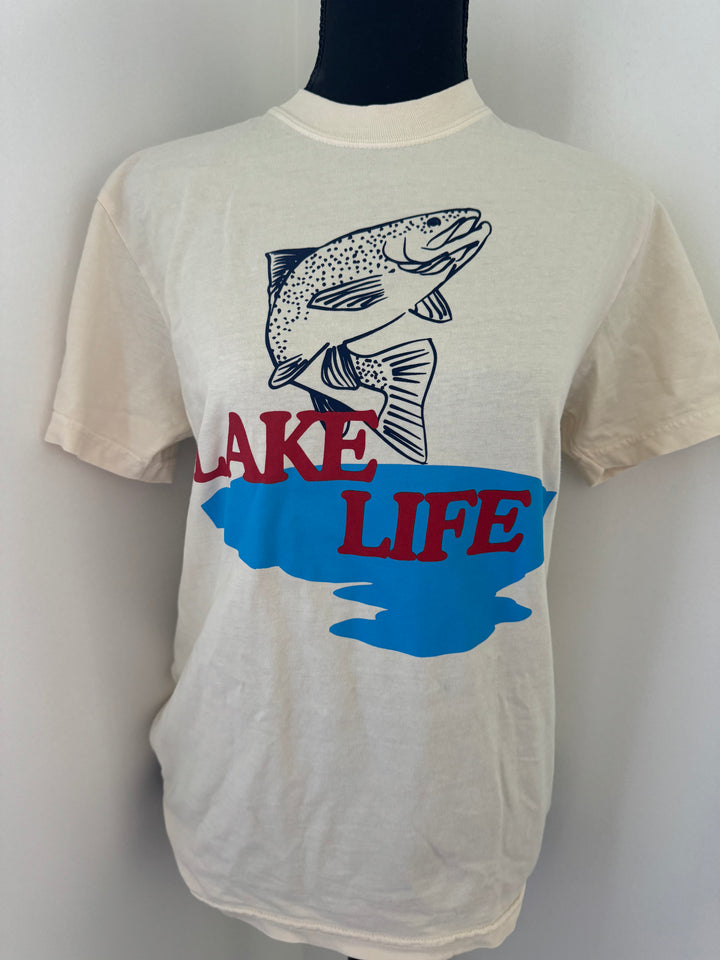 zoomed in view of Lake Life tee printed on a Comfort Colors shirt, made of 100% cotton in natural color with a custom design, offering a true-to-size fit and minimal shrinkage.