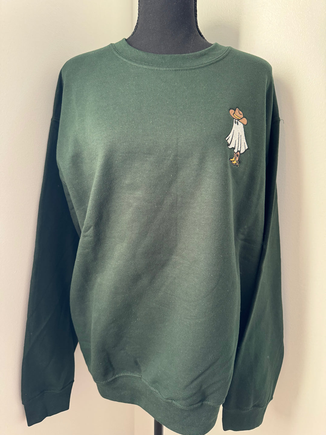 mannequin view of green colored Western Ghost Embroidered Halloween Crewneck Sweatshirt in soft, durable fabric with an oversized unisex fit, featuring a minimalist ghost design, available at Onyx Native.