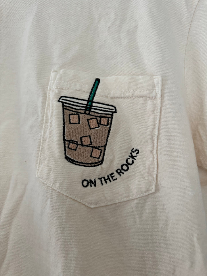 pocket detailed view of 'On the Rocks' Embroidered Pocket Tee in cream with custom colors. Perfect for coffee lovers.