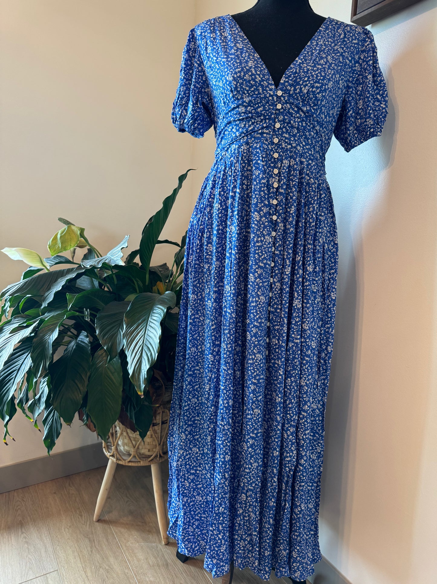 mannequin view of Florence Button Down Maxi Dress with floral print, functional button-down front, ruched waist with smocked elastic back, puff sleeves, and full lining.