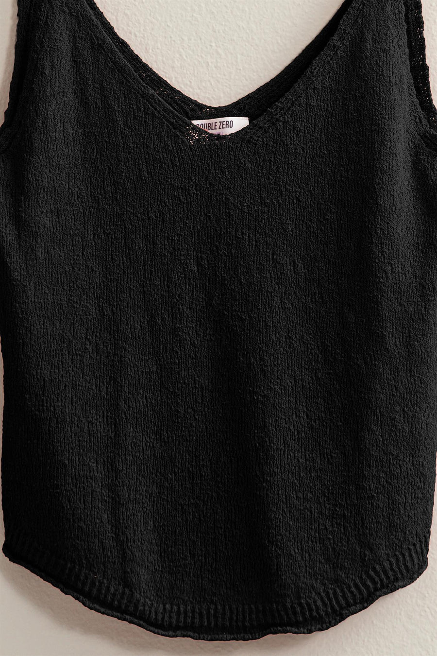 black colored Terry Sleeveless Top with a V neck and shoulder straps, featuring a relaxed fit. Made from 75% cotton and 25% polyester, ideal for pairing with shorts, pants, or skirts.