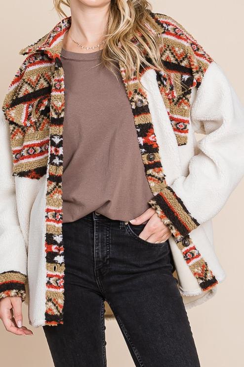 Color block collared shacket with a button-down front, chest pocket, and scoop hem. Features a loose fit and is made from 100% polyester