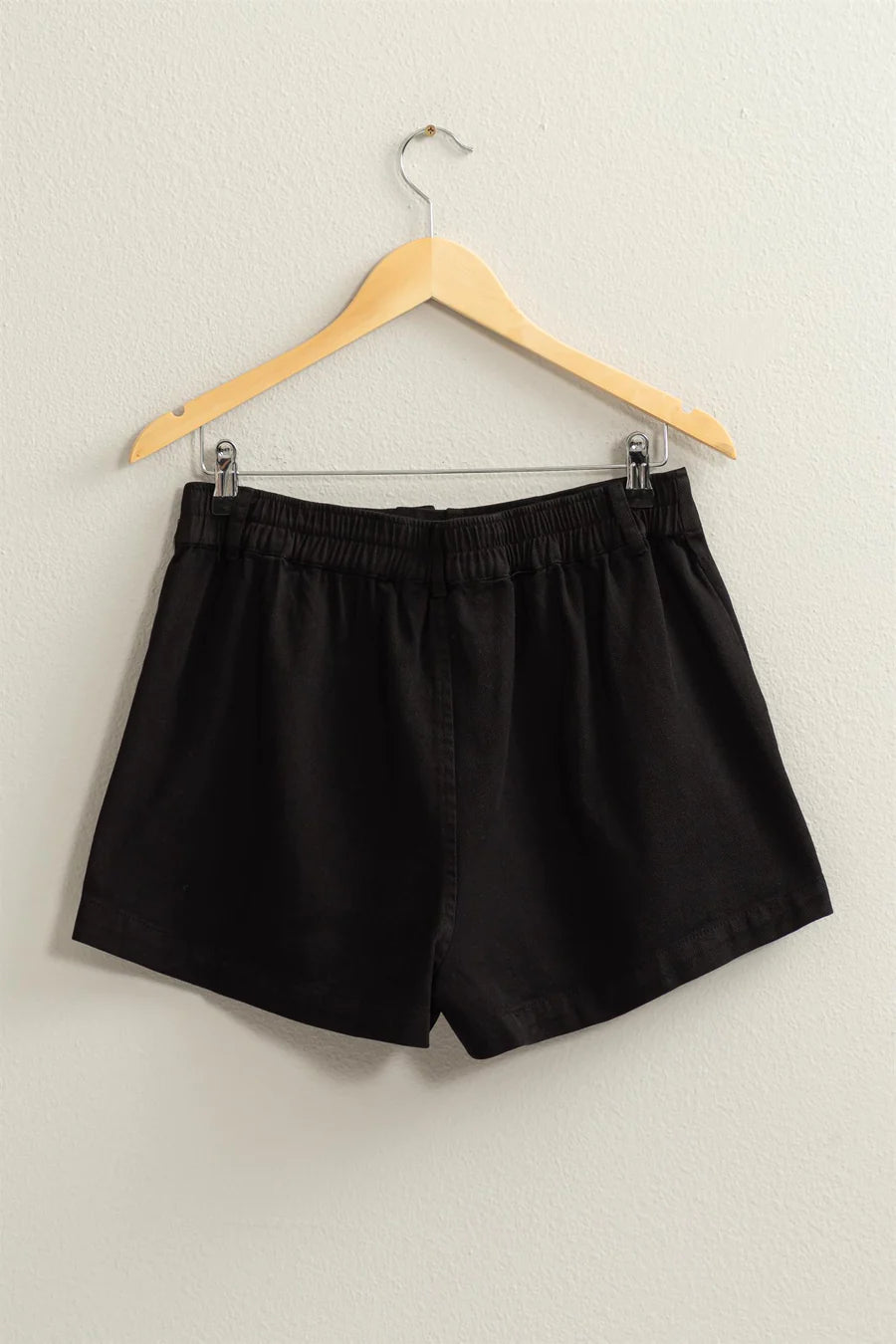 back view of High-waisted shorts featuring pigment garment dyeing, button closure, belt loops, and side pockets. Made from 100% cotton for a carefree summer vibe.