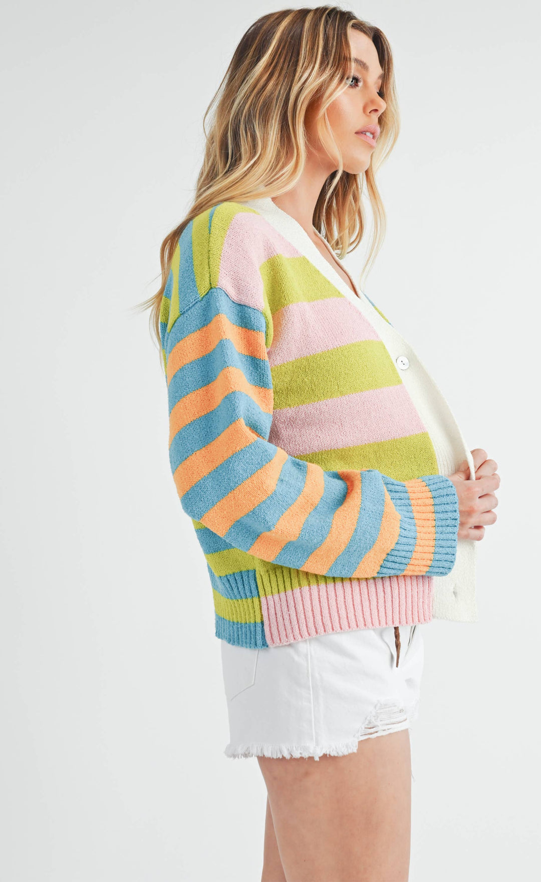 slight side view of Flavia Sweater featuring mixed stripes, drop-shoulder design, cashmere-blend fabric, deep V-neck, and front button closure.