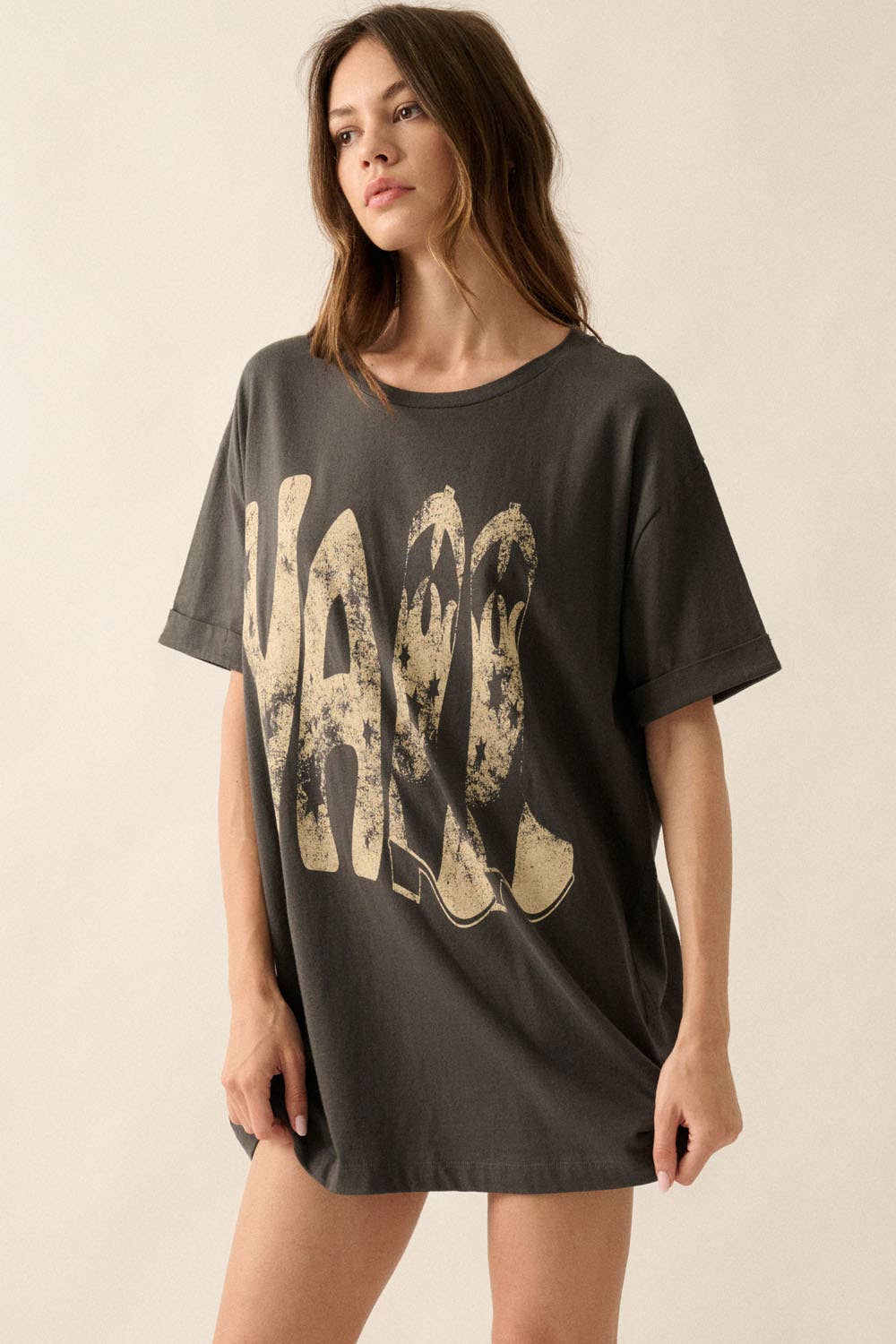 slight side view of Ya'll Cowboy Boots Vintage Wash Graphic Tee with 'Ya'll' text, stars, and cowboy boots graphics. Oversized fit, mineral washed, round neckline, short cuffed sleeves, and dropped shoulders