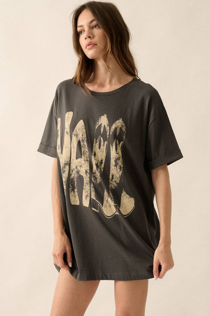 slight side view of Ya'll Cowboy Boots Vintage Wash Graphic Tee with 'Ya'll' text, stars, and cowboy boots graphics. Oversized fit, mineral washed, round neckline, short cuffed sleeves, and dropped shoulders