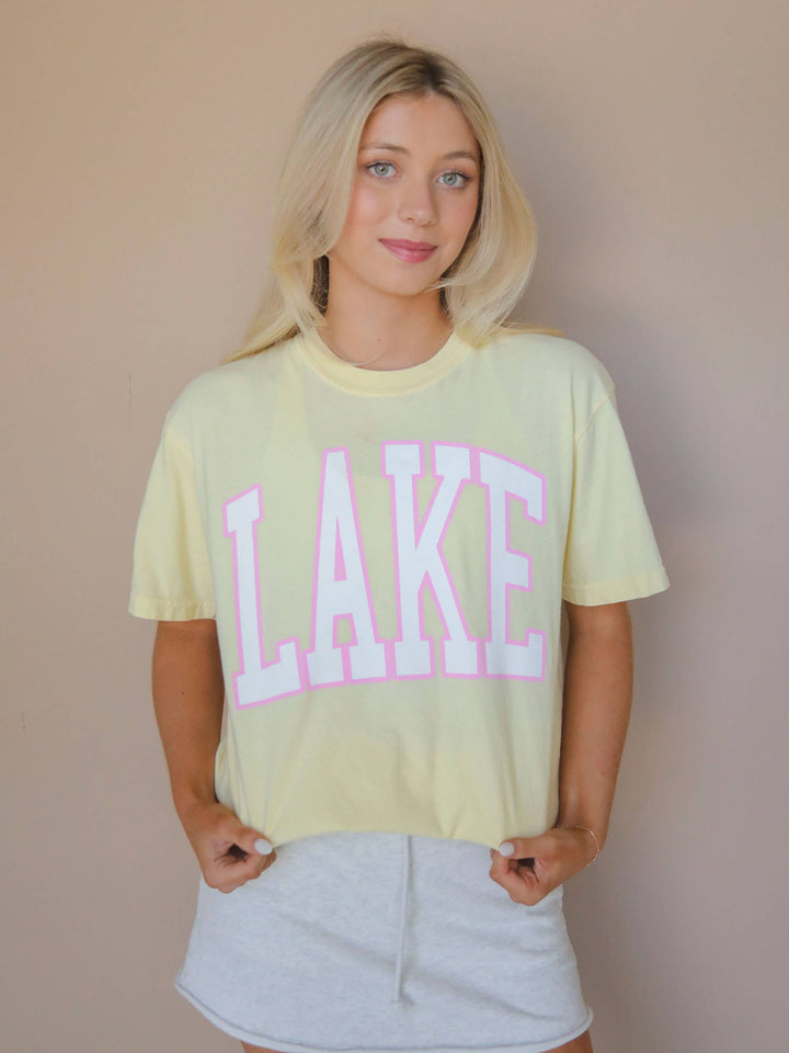 lake view LAKE Oversized Tee — sunshine yellow Comfort Colors® tee with varsity pink and white lettering, perfect for lake days by Onyx Native