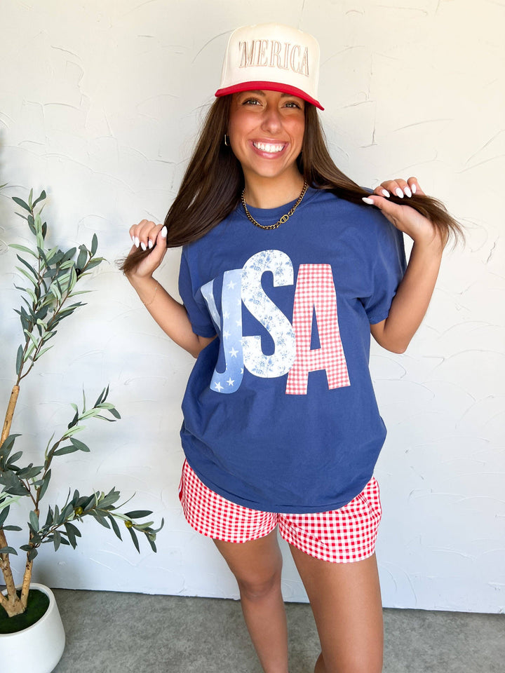 plaid shorts with USA Picnic Tee — patriotic Comfort Colors® unisex cotton tee with screen-printed graphic, perfect for outdoor gatherings by Onyx Native