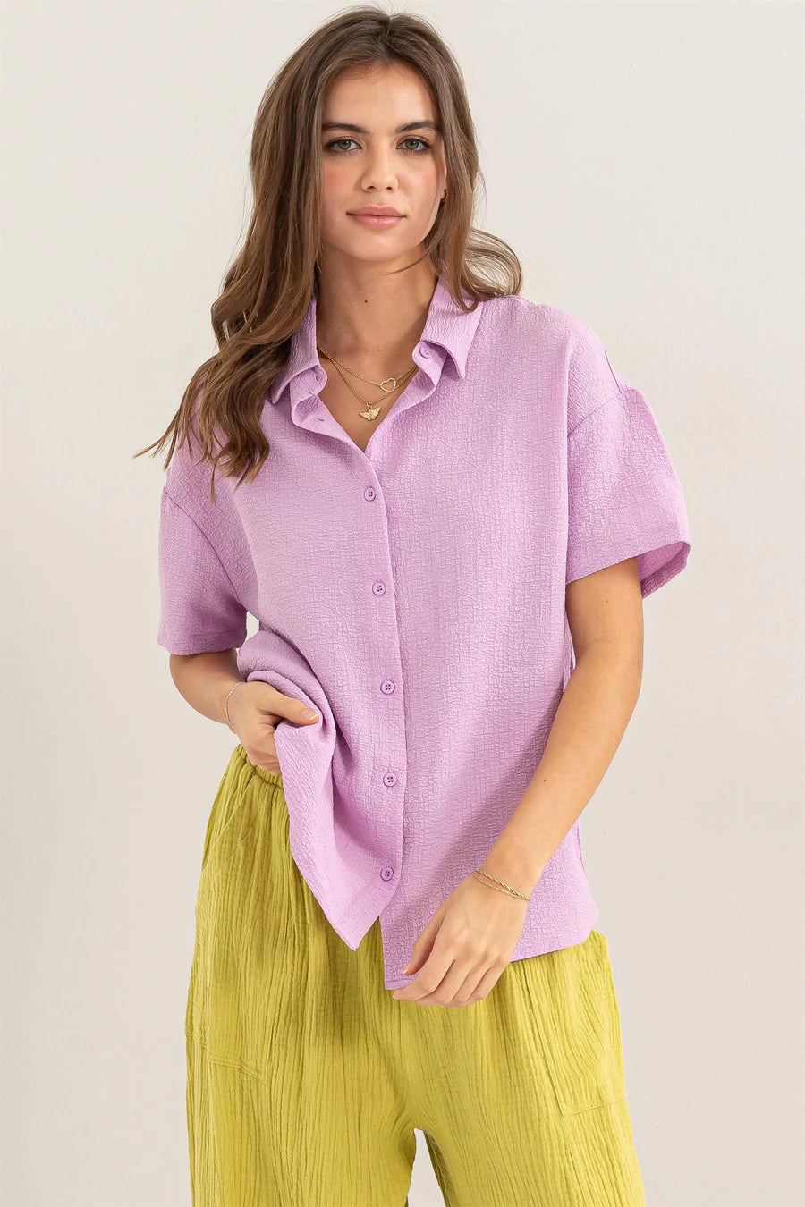 front view of Lavender Haze Button Down Shirt - Textured fabric with point collar, drop shoulders, short sleeves, and a relaxed fit. Tuck-in option for a polished look.
