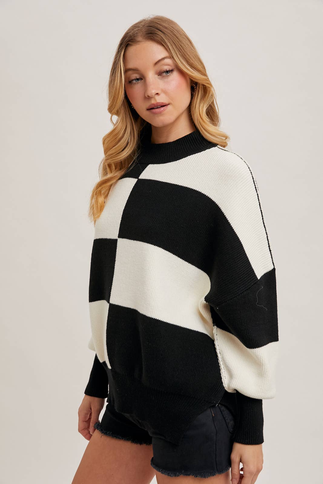 Black Color Block Sweater with dolman sleeves, soft knit fabric, and a stylish design, perfect for versatile styling, available at Onyx Native.