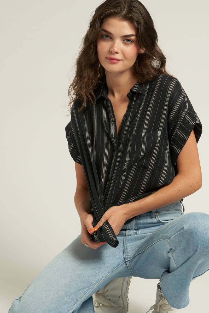 model wearing Stevie Striped Sleeve Button Down Top with short striped sleeves, made from 100% cotton. Model is 5'10" and wearing a size small.