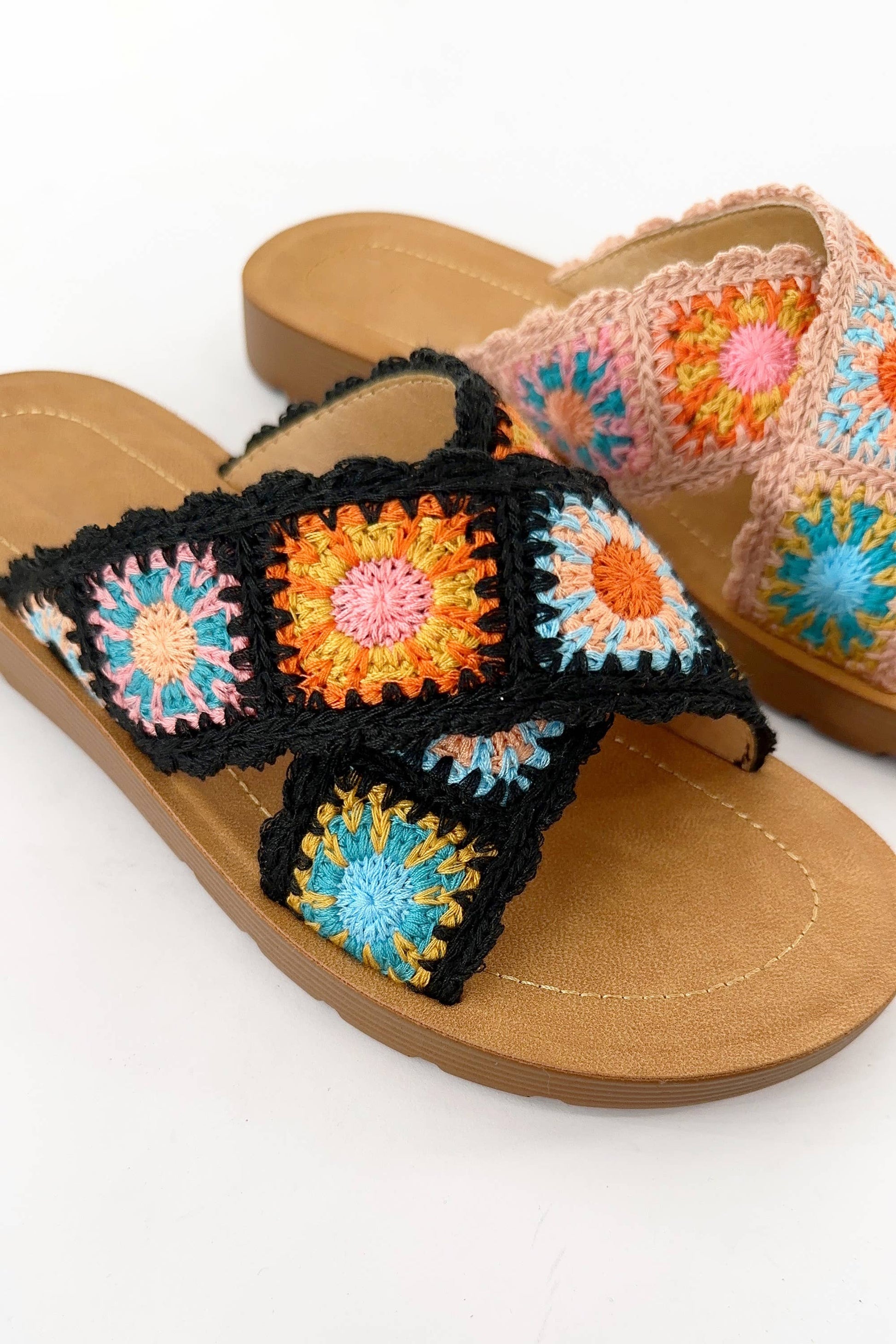 close up detial of Granny Square Floral Crochet Slide Sandal in beige with cross-strap design, colorful floral crochet pattern, wide double straps, round toe, and rubber outsole.