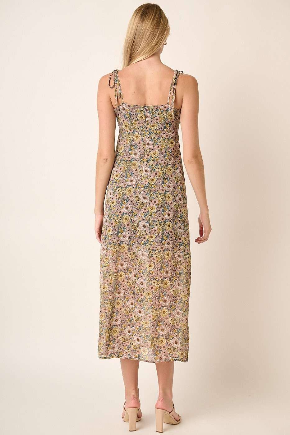 back view of Finley Flower Print Side Slit Maxi Dress with a sweetheart neckline, spaghetti straps with tie detail, front and side slit, and maxi length. Lined for comfort. 