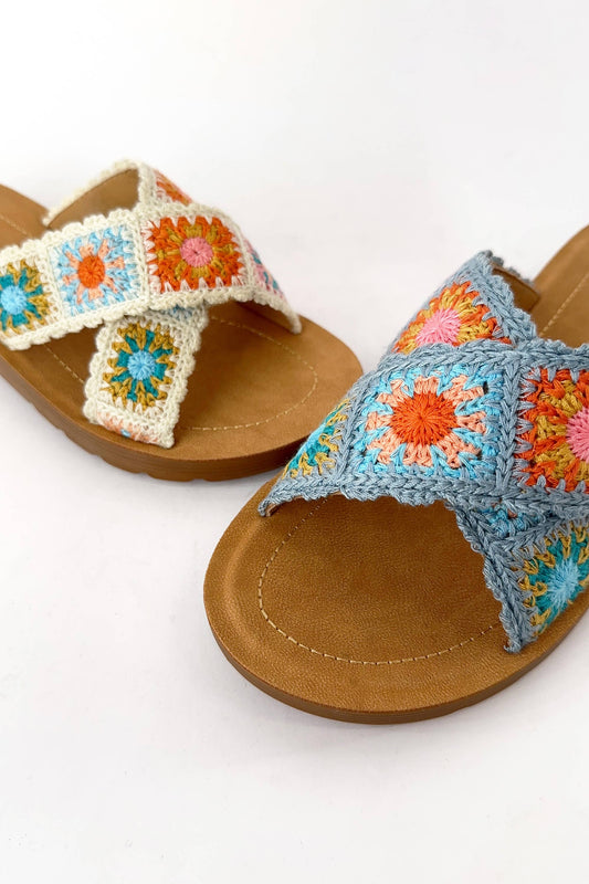 Granny Square Floral Crochet Slide Sandal in beige with cross-strap design, colorful floral crochet pattern, wide double straps, round toe, and rubber outsole.