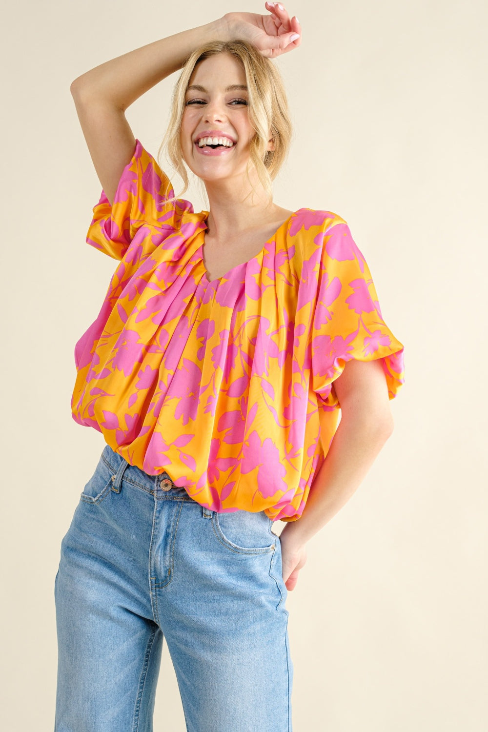 arm up view of Printed satin bubble hem top with a ruched sheer design and a playful silhouette. Made from 100% polyester, offering a soft, smooth feel. Available in sizes S to 3XL.