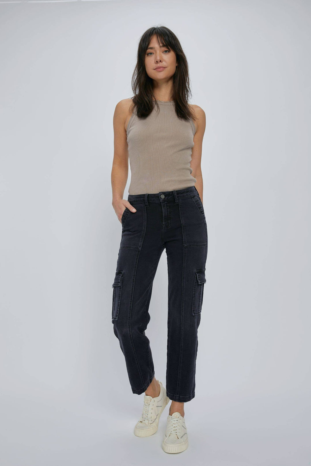 zoomed out front view of Black stretch cargo pocket straight jeans. Features include a rise of 10 inches and an inseam of 28 inches. Model is wearing size 26. Made of 65% cotton, 21% rayon, 11% polyester, and 2% spandex.