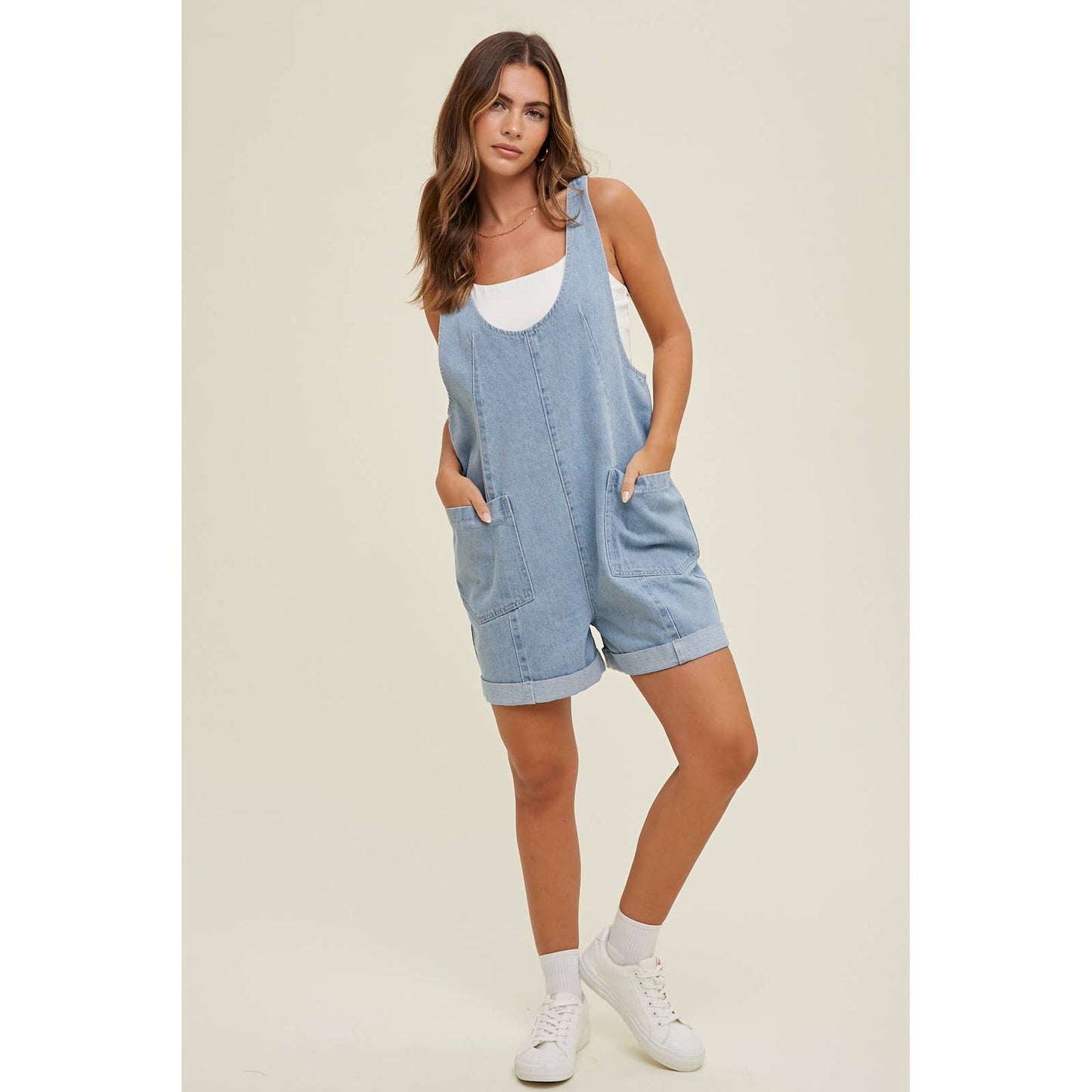 full view of Cotton Denim Seam Detail Romper with adjustable straps and front pockets, made of 100% cotton. Available for pre-order with color variations possible due to lighting and monitor differences.