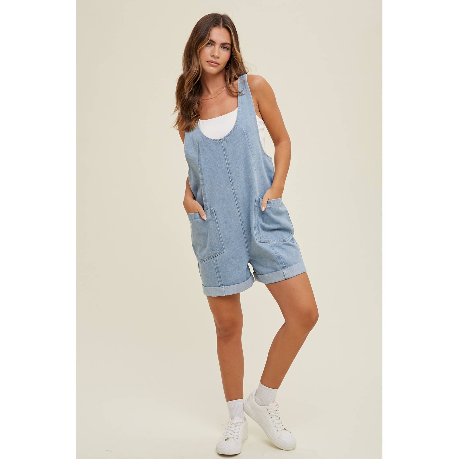 full view of Cotton Denim Seam Detail Romper with adjustable straps and front pockets, made of 100% cotton. Available for pre-order with color variations possible due to lighting and monitor differences.