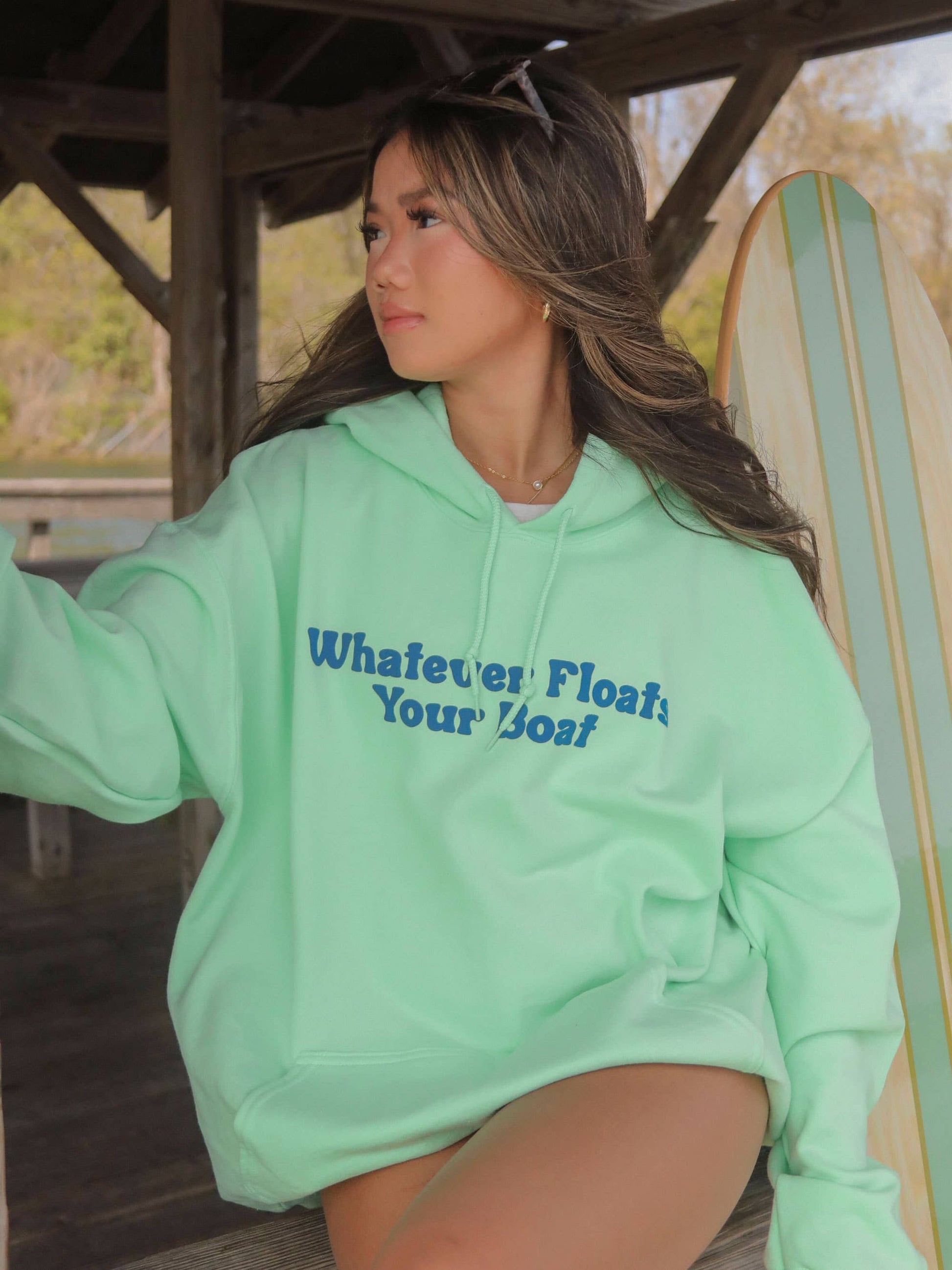 front view of Whatever Floats Your Boat' Hoodie in lime green with bright front and back designs. Perfect for lake days. Available in sizes Small to XL. 