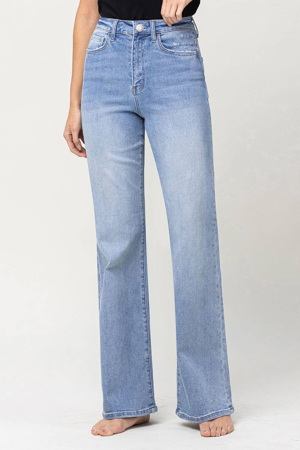 front view of 90's vintage super high rise flare jeans with comfort stretch denim, full length, and flare legs. Front rise: 11.5 inches, inseam: 32 inches, leg opening: 20 inches. Model is 5'9'' wearing size 26.