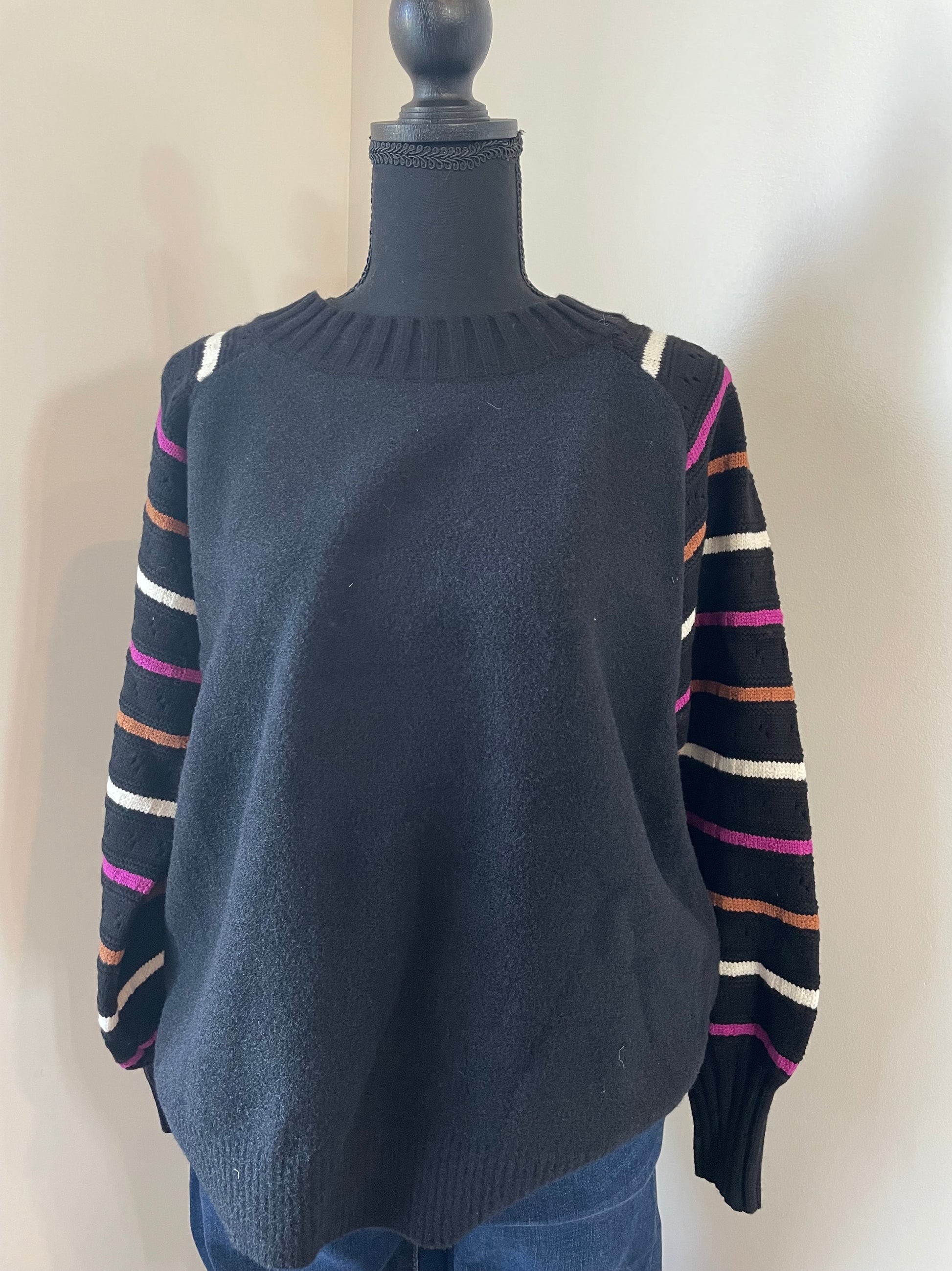 mannequin view of Relaxed fit pullover with ribbed neck, sleeve, and waist details. Features balloon sleeves for added style.