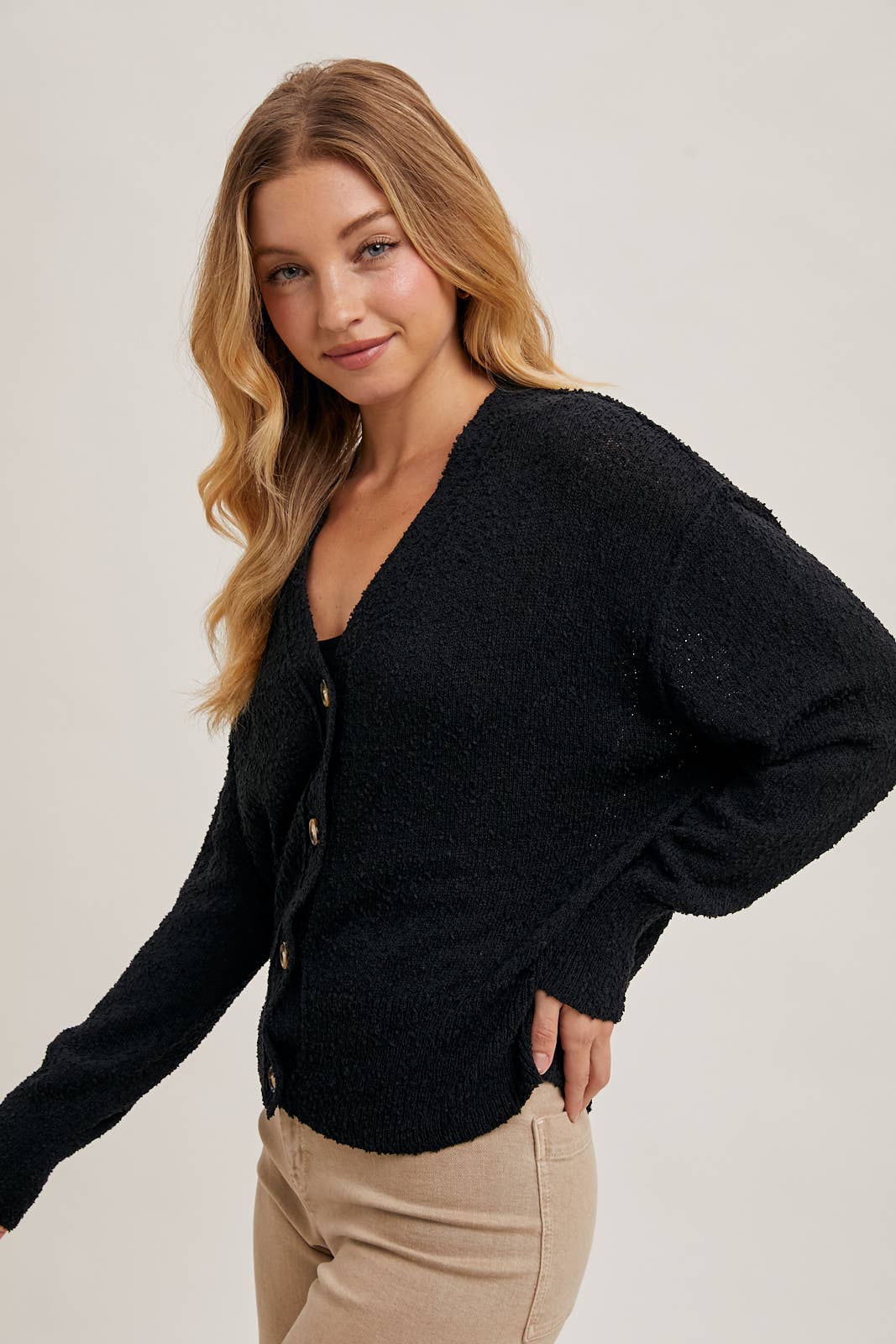 styled view of Black Betty Button-Down Cardigan with a classic button front, relaxed fit, and long sleeves, made from soft knit fabric for cozy layering, available at Onyx Native.