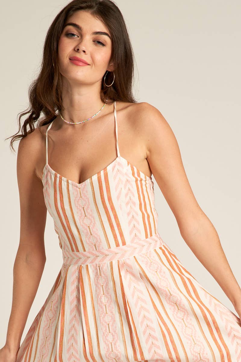 zoomed in view of neck line of Marie Back Cross Cami Midi Dress in white and coral, made from 98% cotton and 2% lurex. Features a back cross design. Model is 5'8" and wearing a size small.