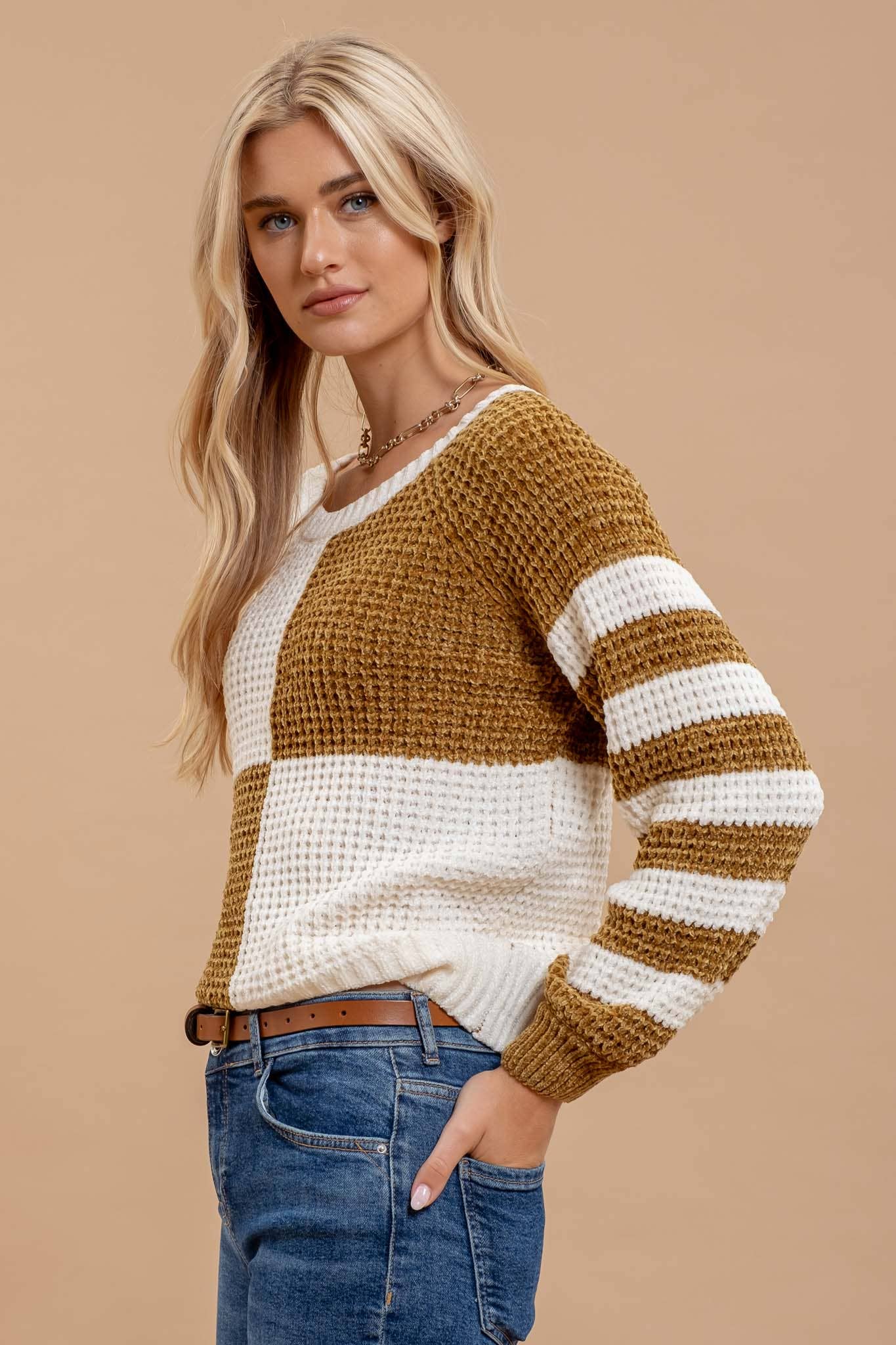 slight side view of Mustard Checkered and Stripe Sweater with a round neckline and drop shoulders, featuring velvet knit texture, available at Onyx Native.