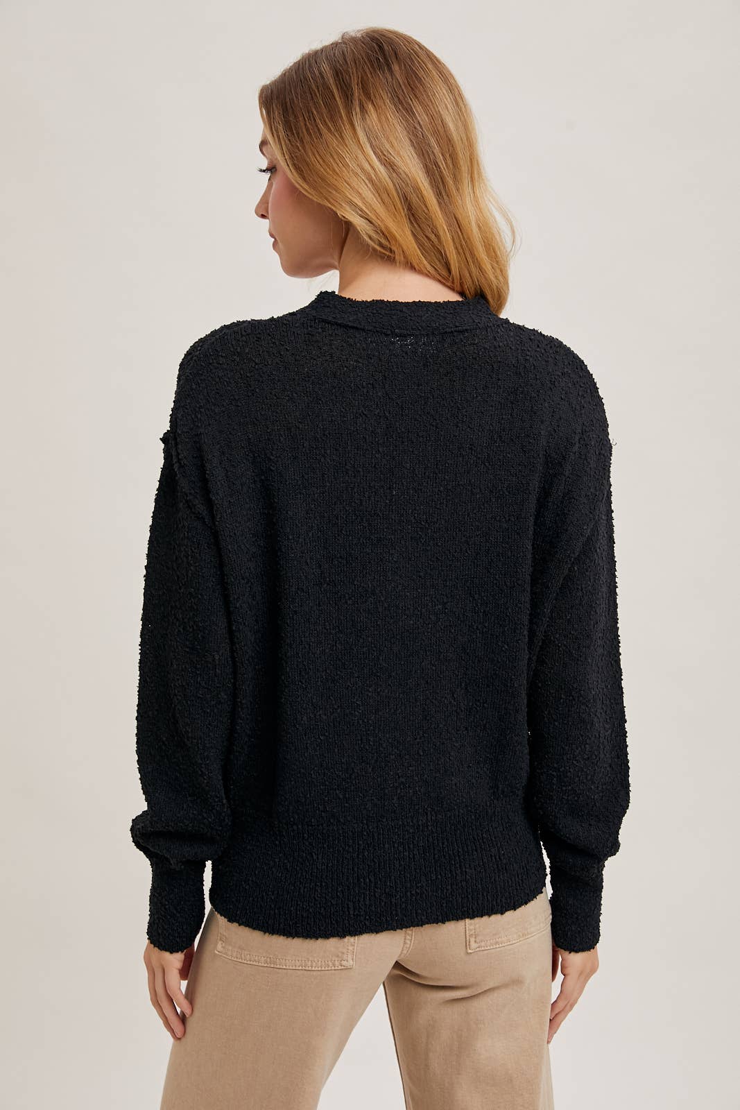 back view of Black Betty Button-Down Cardigan with a classic button front, relaxed fit, and long sleeves, made from soft knit fabric for cozy layering, available at Onyx Native.