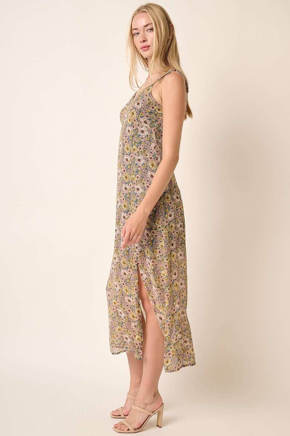 side view of Finley Flower Print Side Slit Maxi Dress with a sweetheart neckline, spaghetti straps with tie detail, front and side slit, and maxi length. Lined for comfort. 