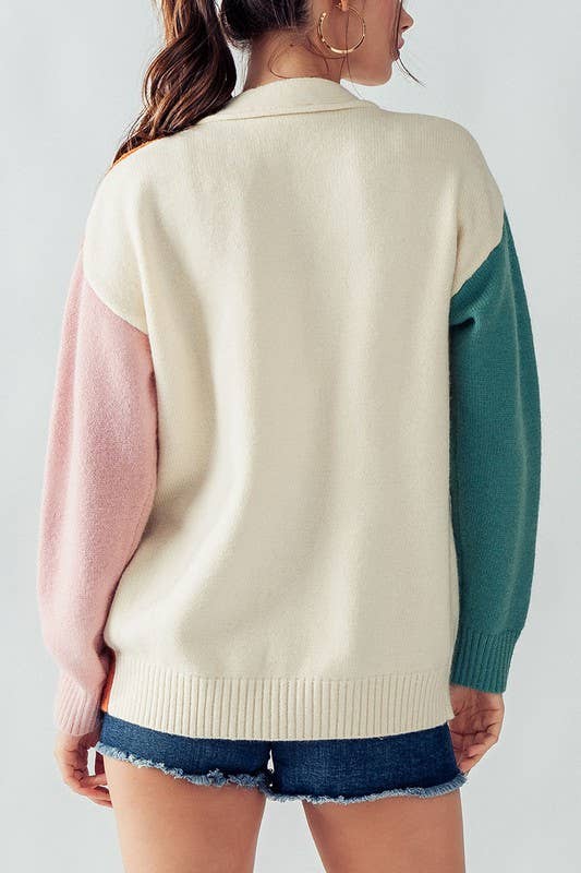 back view of Hailee Multicolor Cardigan Sweater with button-down front, colorful ribbed cuffs and hem, designed for a slightly oversized fit, available at Onyx Native.